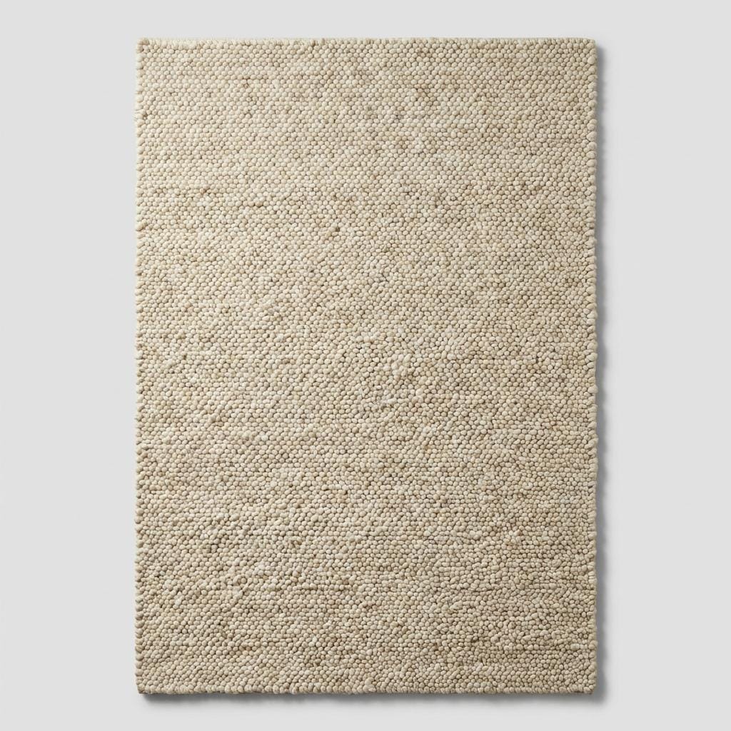 Chunky wool neutral area rug in thick textured cream, perfect for cozy modern interiors