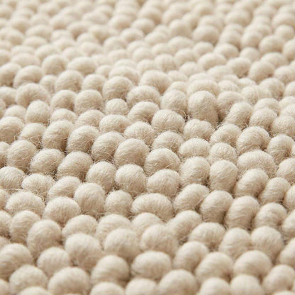 Chunky wool pebble rug in thick ivory with textured loops for cozy modern living rooms