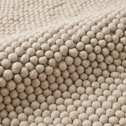 Handmade chunky wool rug with thick cream loop pile, cozy textured neutral area carpet