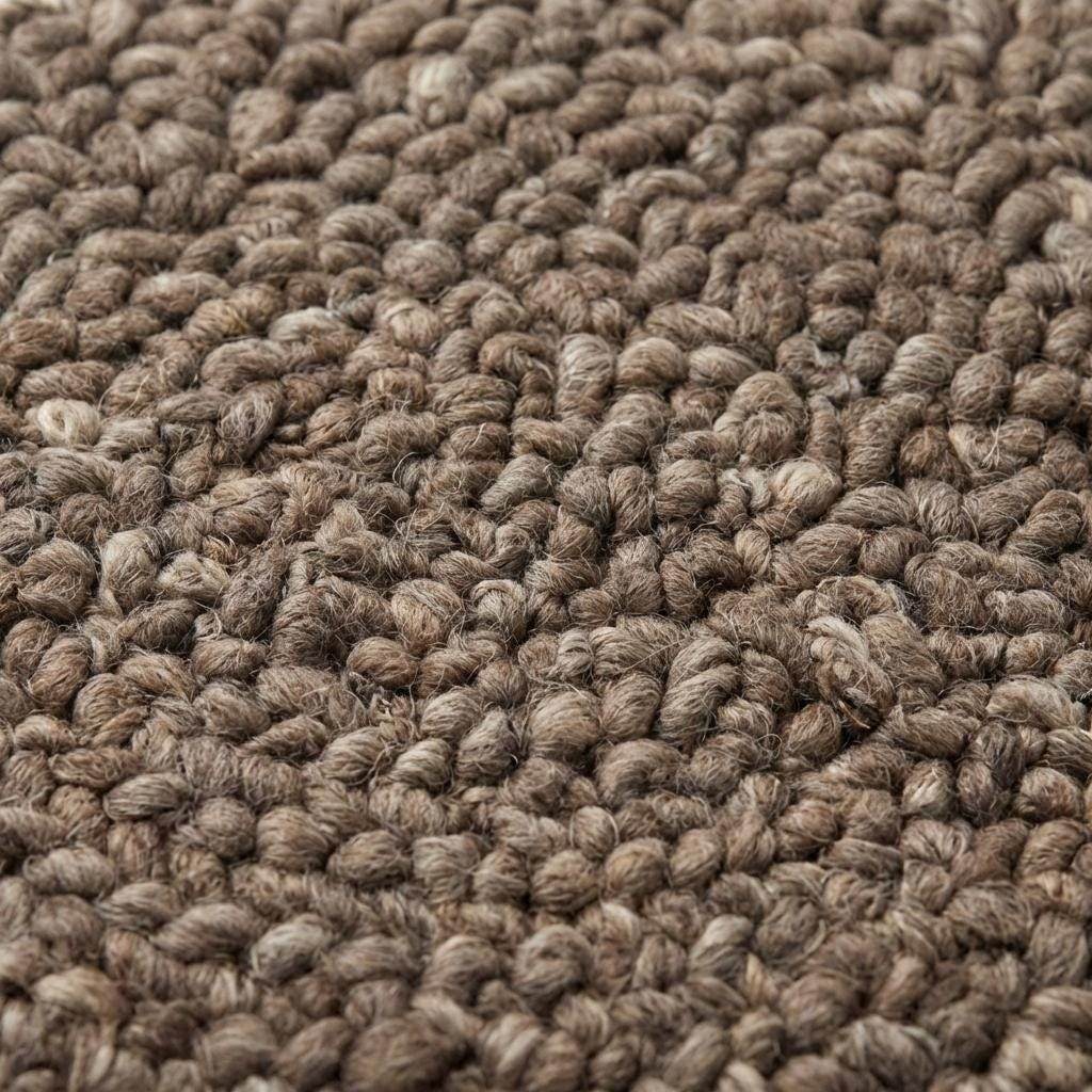 Handmade chunky wool rug with thick loop knit in neutral tones for cozy farmhouse decor