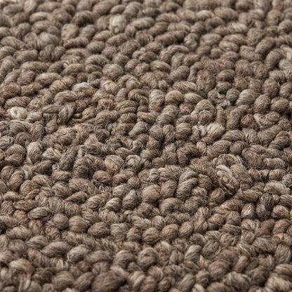 Handmade chunky wool rug with thick loop knit in neutral tones for cozy farmhouse decor