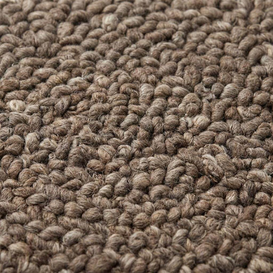 Handmade chunky wool rug with thick loop knit in neutral tones for cozy farmhouse decor