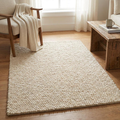 Handwoven chunky wool rug with thick cream loop pile in modern farmhouse living room setting