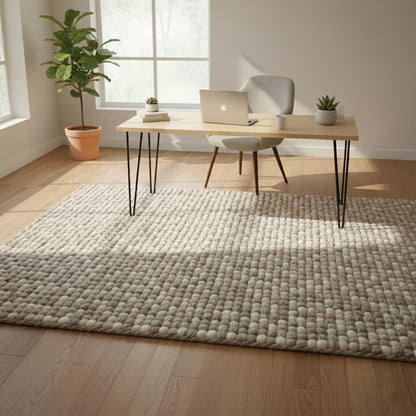 Handwoven chunky wool rug in neutral tones with thick texture for cozy Scandinavian living room decor