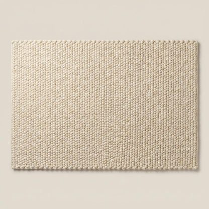 Thick cream wool area rug featuring textured pebble weave design, ideal for boho, Scandinavian, and organic modern home decor.