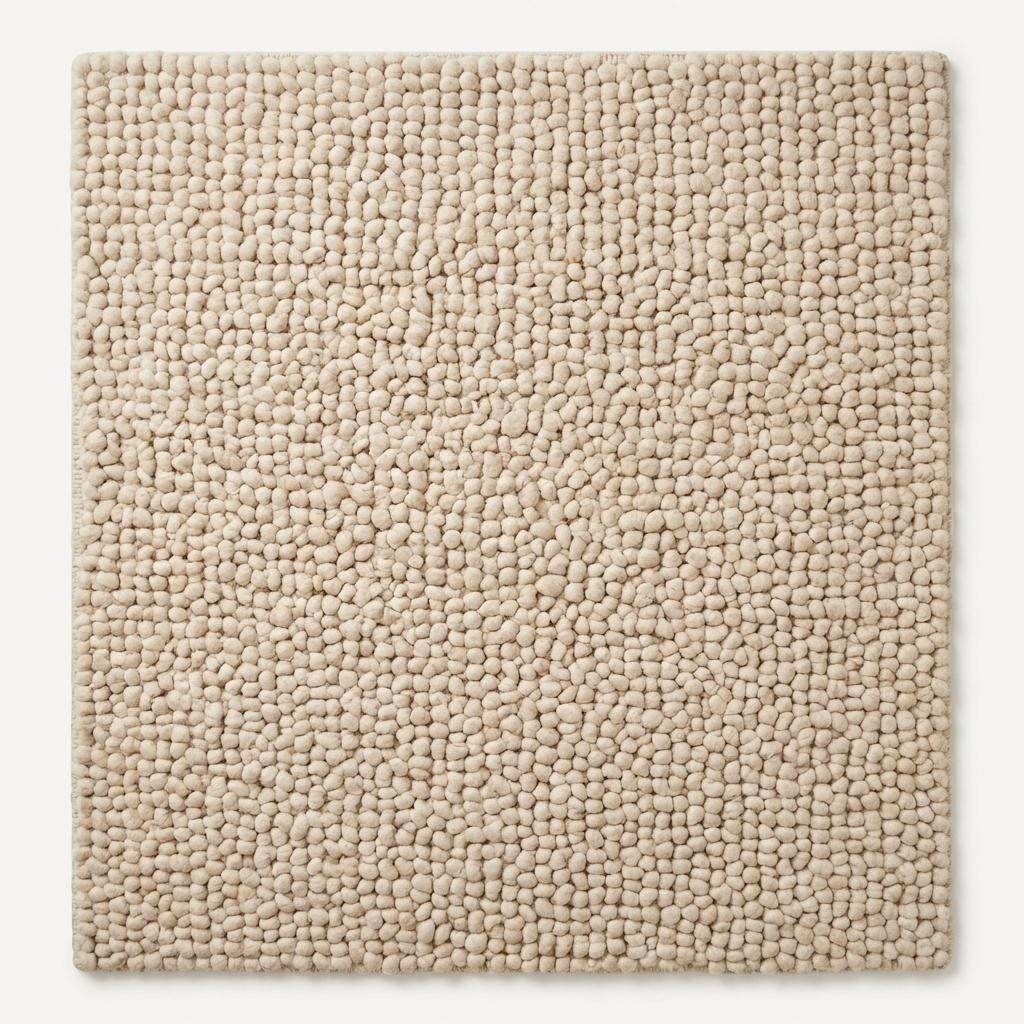 Handmade chunky knit wool rug soft plush texture close-up for cozy home decor styling