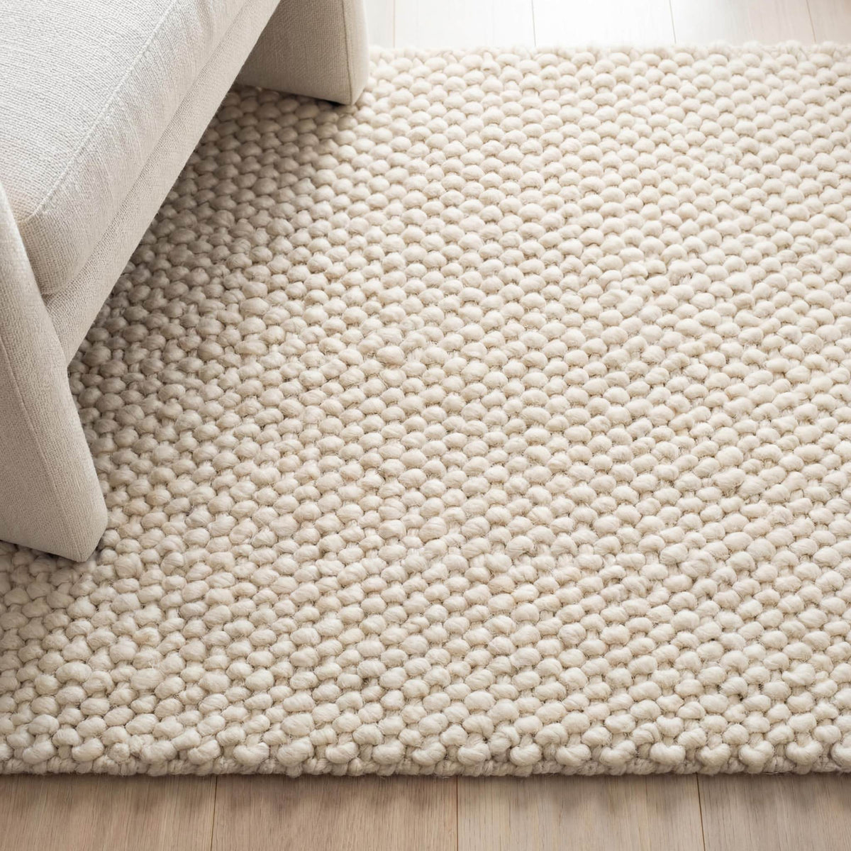 Chunky wool rug with neutral textured loop pile, cozy minimalist living room decor