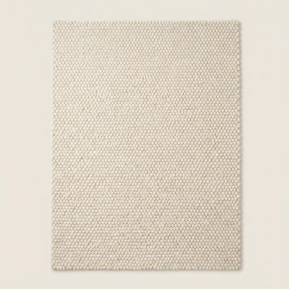 Chunky wool rug with neutral loop pile texture in minimalist living room