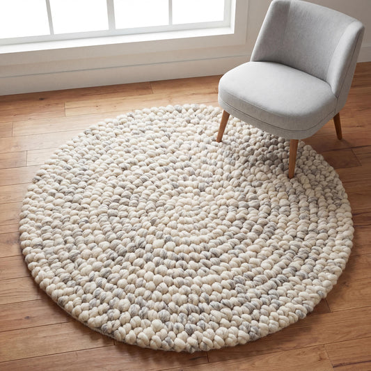 Round chunky wool rug with thick pebble texture in neutral tones for Scandinavian decor