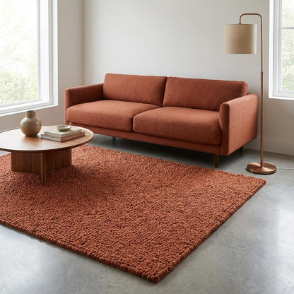 Chunky wool rug in warm rust tone with plush looped texture for cozy living room or bedroom decor