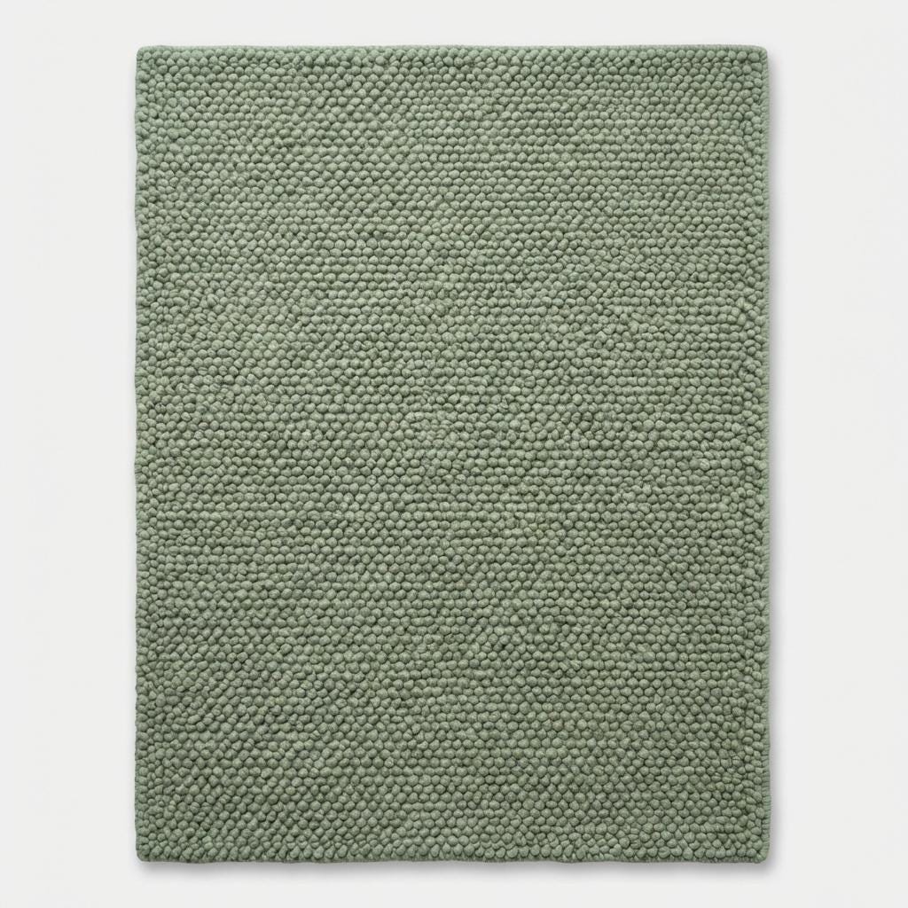 Chunky wool textured sage green area rug with thick looped plush surface for cozy modern organic interiors