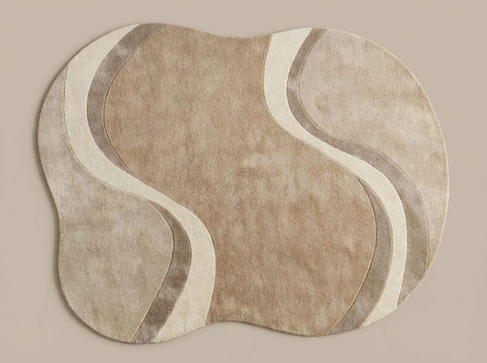 Modern curved rug living room with wavy abstract pattern in beige, cream, and taupe organic shape
