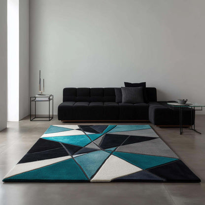 Deep teal area rug with hand tufted plush geometric pattern in deep teal, blue, and ochre, durable poly-blend material, modern abstract carpet design.
