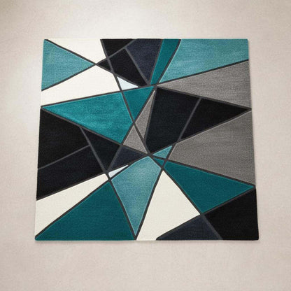 Deep teal area rug with abstract geometric design and hand tufted plush texture