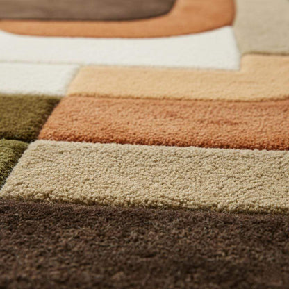 Mid century modern rug with olive green and rust orange geometric tufted design for boho retro decor