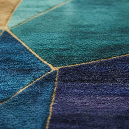 Geometric abstract rug in blue, teal, gold with stained glass design and modern artistic style