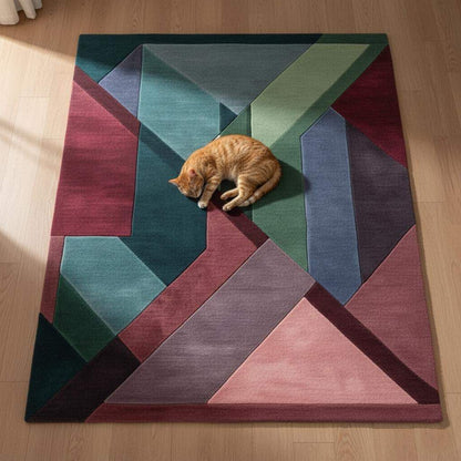 Geometric area rug with triangles in burgundy, green, teal, blush pink, and plum jewel tones.