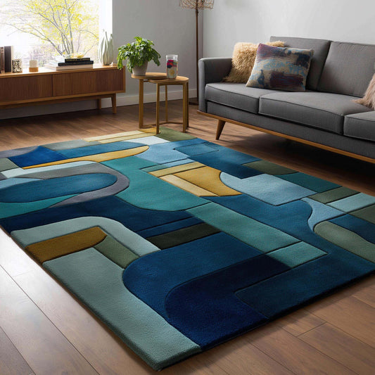 Mid-century modern geometric block area rug in navy, teal, gold, and olive colors with abstract patterns