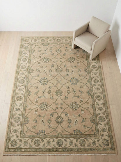 Hand-Knotted Oushak wool rug in muted sage green with floral pattern and natural wool texture