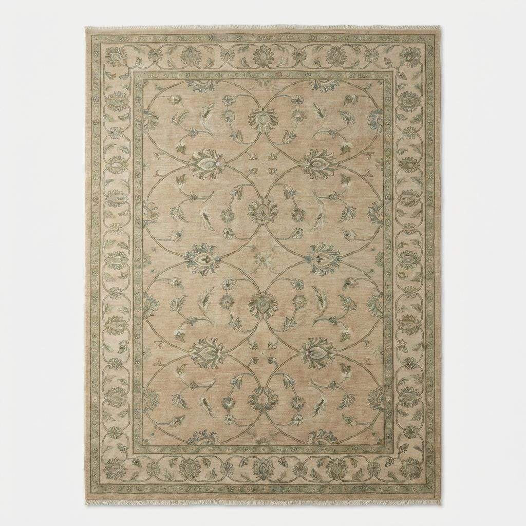 Overhead view of a traditional hand-knotted rug showing the symmetrical floral vine border and soft, muted earth-tone palette.