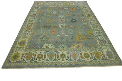 Hand-knotted vintage Oushak wool rug with intricate floral Turkish design in green and blueish-green tones for living room decor