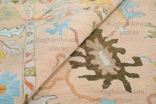 Hand-Knotted Oushak Wool Rug in light pink, dark brown, and purple with floral designs for living room decor