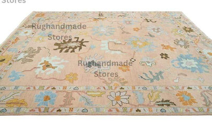 Hand-knotted Oushak wool rug with vintage floral design in light pink, dark brown, and purple accents for living room decor