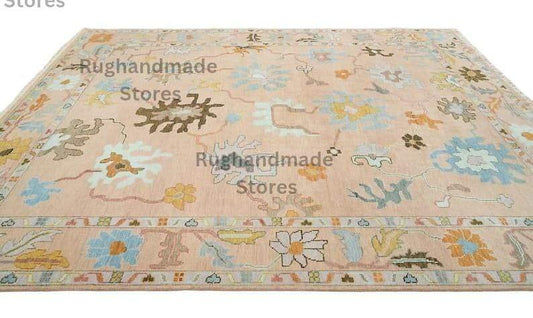 Hand-knotted Oushak wool rug with vintage floral design in light pink, dark brown, and purple accents for living room decor