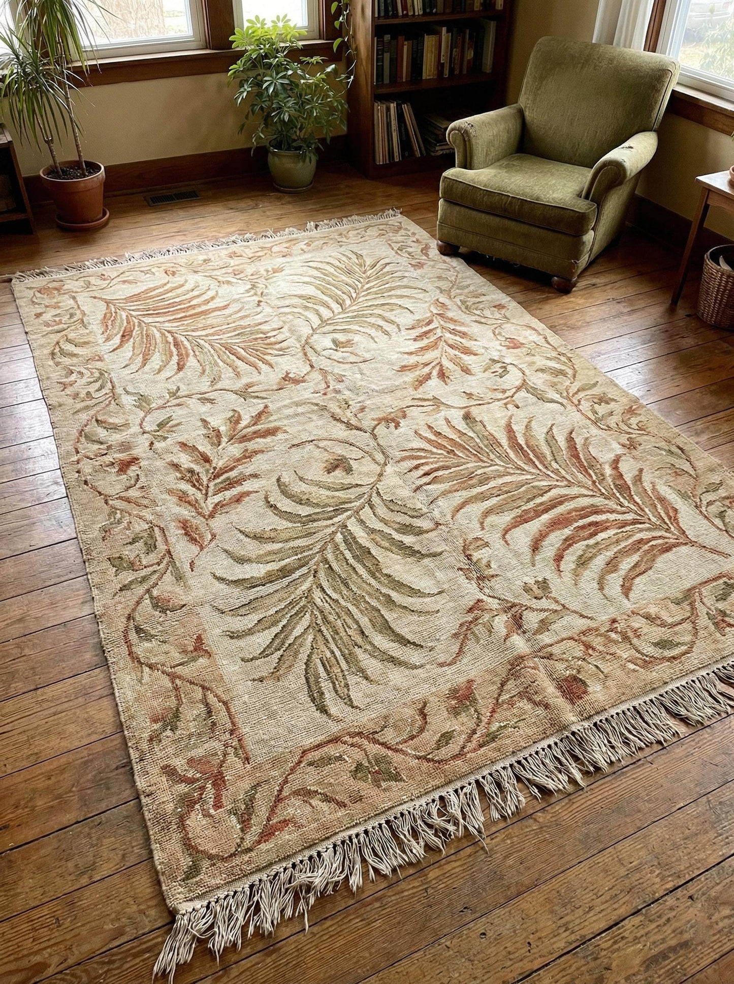 Hand-knotted wool area rug with sage green botanical pattern and natural wool texture
