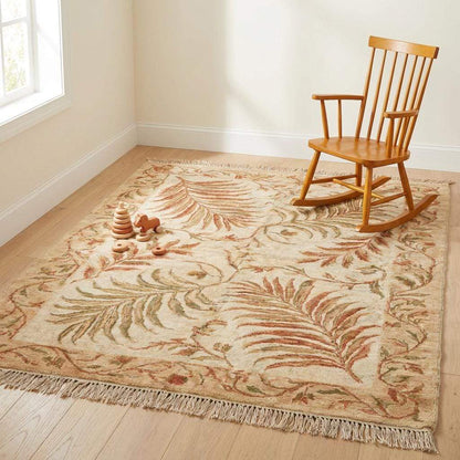 A transitional hand-knotted rug styled in a cozy home library next to a green velvet armchair and indoor plants.