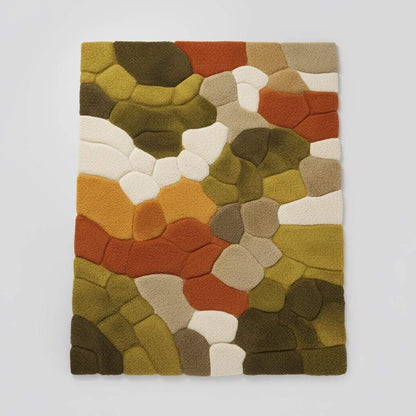 Hand tufted pebble rug with soft textured wool in olive green and burnt orange, ideal for Scandinavian decor and living rooms.