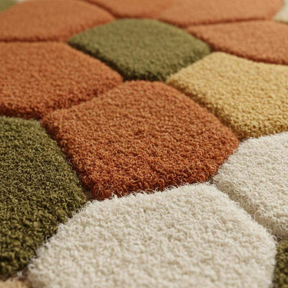 Hand tufted pebble rug with soft textured wool in olive green and burnt orange for Scandinavian decor