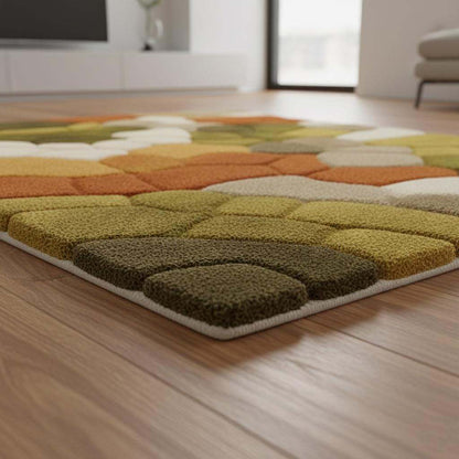 Hand tufted pebble rug with soft textured wool in olive green and burnt orange for Scandinavian decor