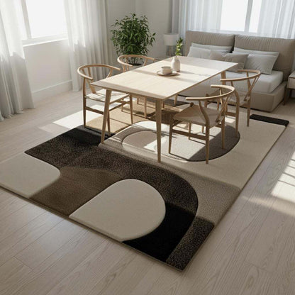 Hand tufted wool rug with abstract black geometric design on ivory background, durable and plush textured floor art