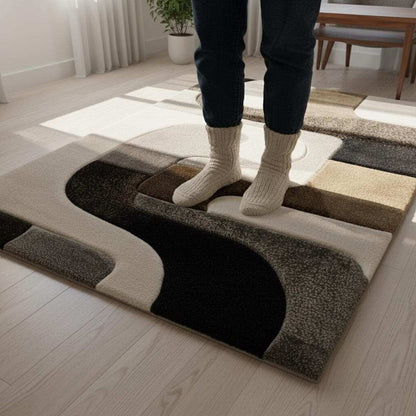 Hand tufted wool rug with abstract black geometric design on ivory background and high-low texture