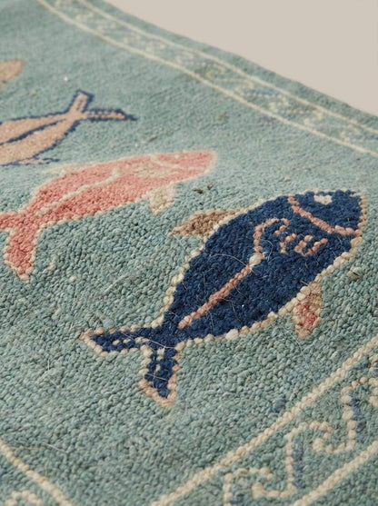 Close-up of hand knotted wool rug showing dense knot structure, soft pile texture, and detailed fish pattern craftsmanship __etsy:7924469615
