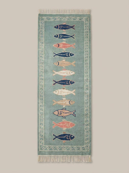 Coastal wool runner rug with fish design placed in bright kitchen space with white flooring and natural light __etsy:7876508872