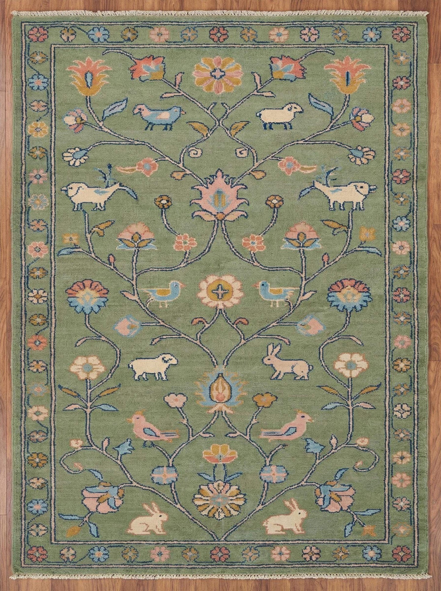 Hand knotted floral area rug with sage green wool and animal motifs for traditional living room decor
