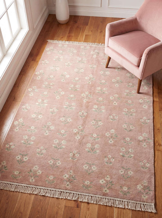 Hand knotted pink floral rug in pastel tones placed in modern living room with soft natural lighting and wooden flooring __etsy:7965663663