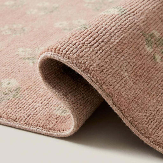 Close-up of hand knotted wool rug showing soft pile texture, fine knots, and delicate floral pattern in pastel pink and green __etsy:7965663851