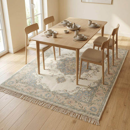 Traditional floral wool rug with detailed border and artisan hand knotted craftsmanship