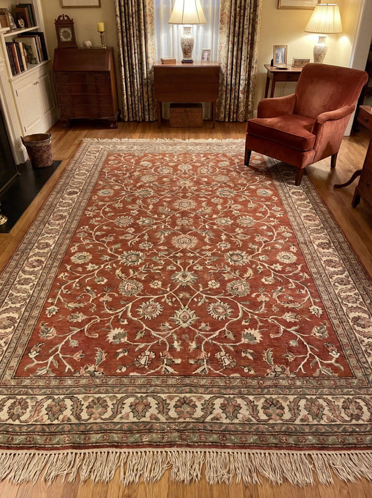 Hand knotted Persian style rug with rust base and floral vine pattern in traditional living room setting __etsy:7958068589
