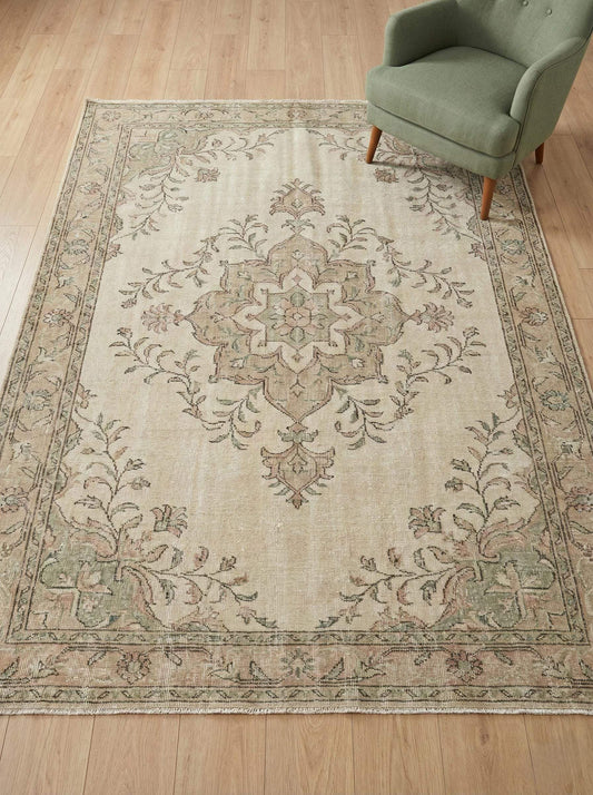 Hand knotted Oushak wool area rug in muted sage green and blush pink with vintage Turkish design