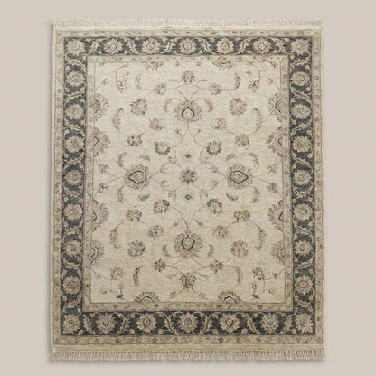 Traditional floral hand knotted rug with neutral beige and muted blue accents