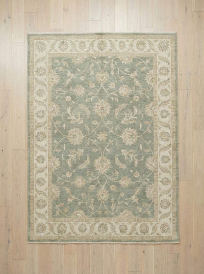 Hand knotted Oushak area rug in sage green wool with floral design and durable texture