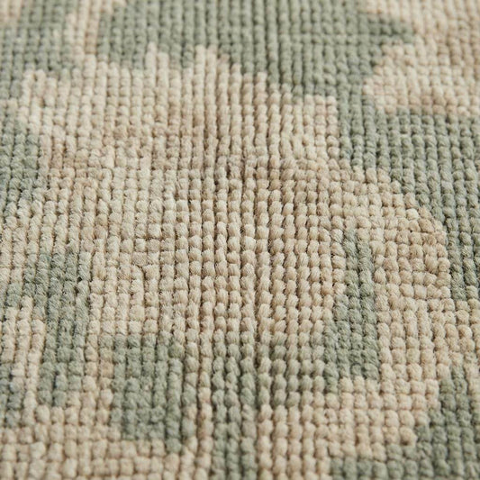 Close up of hand knotted wool pile showing individual knots and natural fiber texture