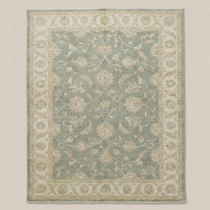 Traditional Oushak style rug with soft green field and ivory floral detailing