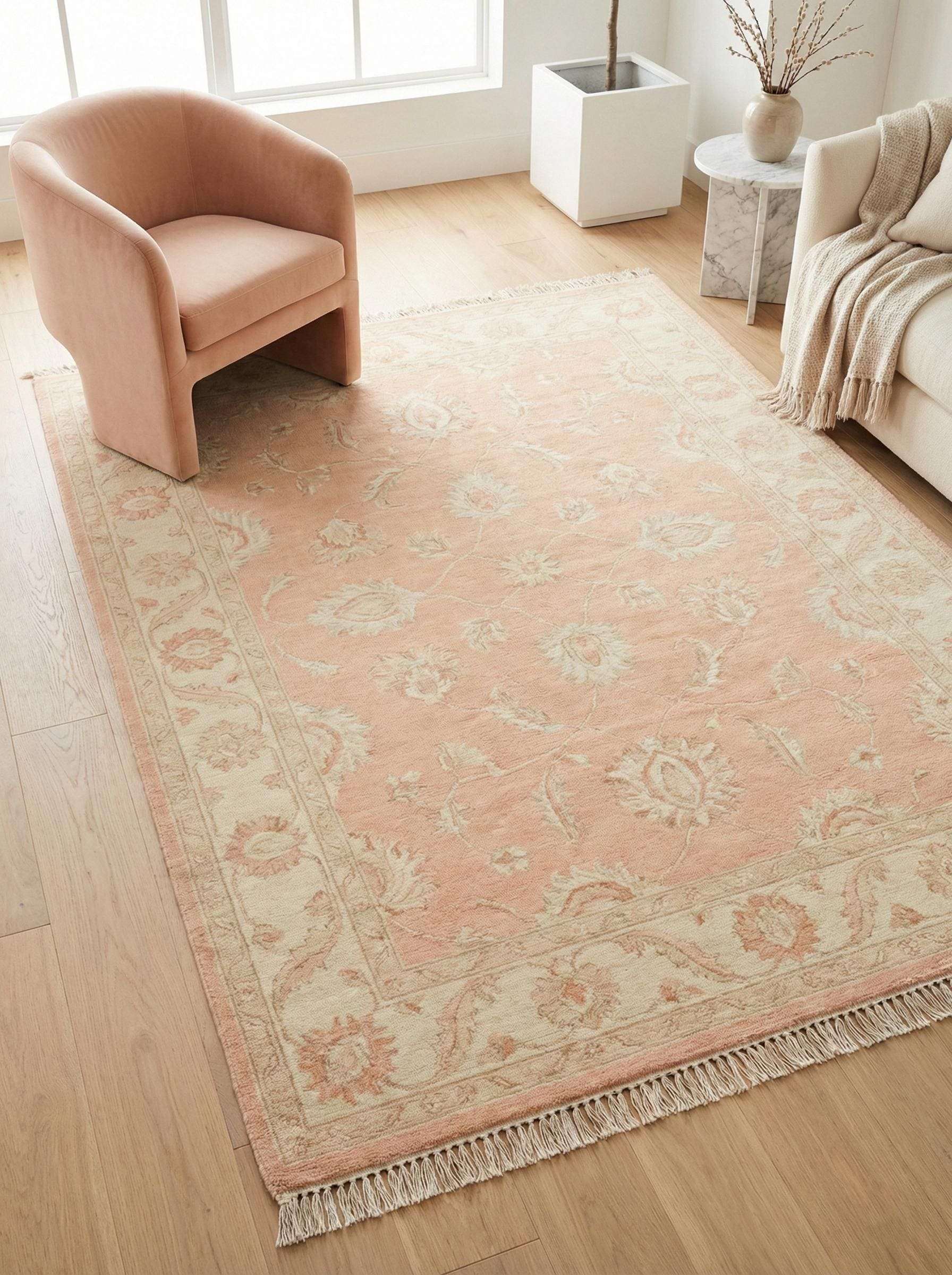 Hand knotted Oushak floral rug in blush peach wool with traditional Persian design for living room and bedroom decor