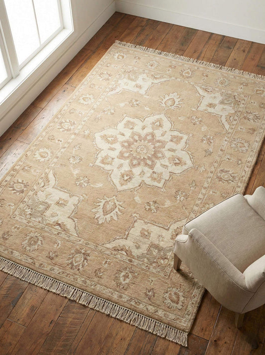 Hand knotted Oushak rug in beige and neutral tones laid flat on a wooden floor, showing overall medallion design. __etsy:7645830528