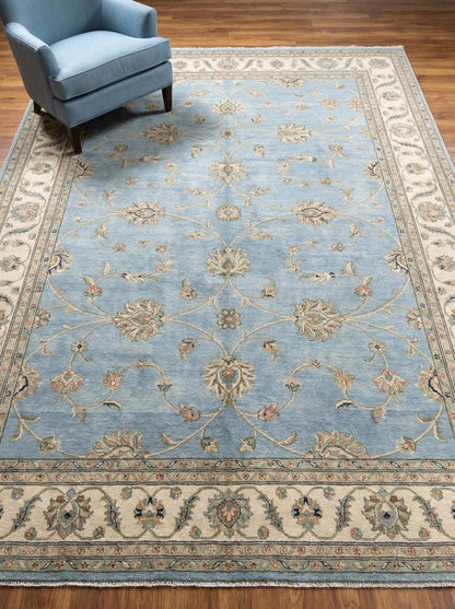 Hand knotted Oushak rug in muted blue with floral design, soft wool area rug for living room and bedroom decor